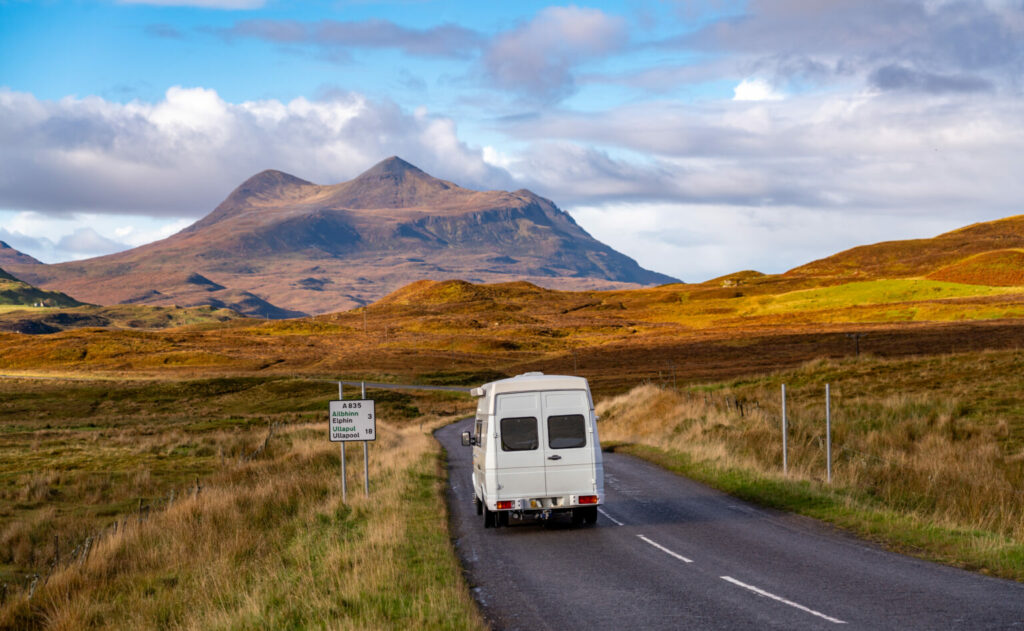 campervan driving through scottish countryside